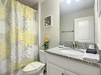 a bathroom with a sink and a toilet and a shower at 4781 - 5BR w Pool 10min Disney 2 Water Parks in Kissimmee
