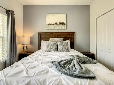 a bedroom with a white bed with a blanket on it at 4874 - 5BR w Pool 10min Disney 2 Water Parks in Kissimmee