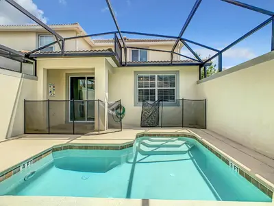 a swimming pool in the backyard of a house at 4874 - 5BR w Pool 10min Disney 2 Water Parks in Kissimmee