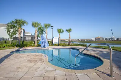 a small swimming pool with palm trees in the background at 4874 - 5BR w Pool 10min Disney 2 Water Parks in Kissimmee