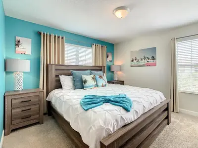 a bedroom with a bed and a blue wall at 4874 - 5BR w Pool 10min Disney 2 Water Parks in Kissimmee
