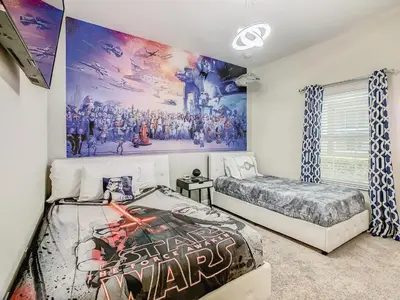 a bedroom with two beds and a large mural at 4916 - 5BR w Pool 10min Disney 2 Water Parks in Kissimmee