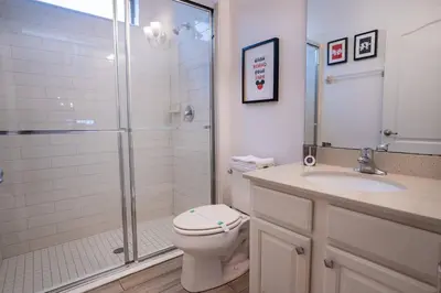 a bathroom with a shower and a toilet and a sink at Veranda Palms 6BR Pool Near Disney Parks in Kissimmee