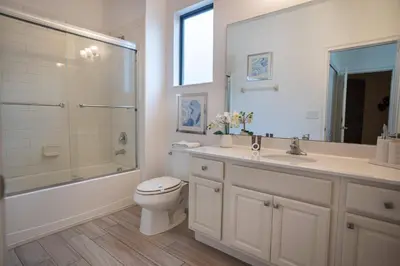 a bathroom with a toilet and a shower and a sink at Veranda Palms 6BR Pool Near Disney Parks in Kissimmee