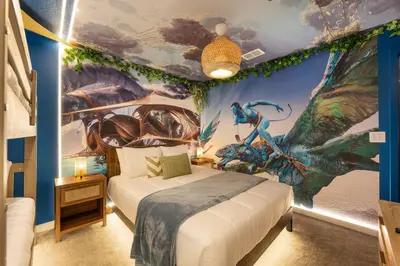 a bedroom with a bed with a painting on the wall at Family 3BR Home Minutes from Disney in Kissimmee