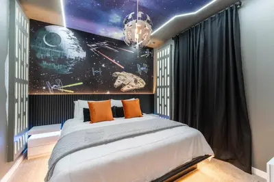 a bedroom with a large bed with a astronomy mural at Family 3BR Home Minutes from Disney in Kissimmee