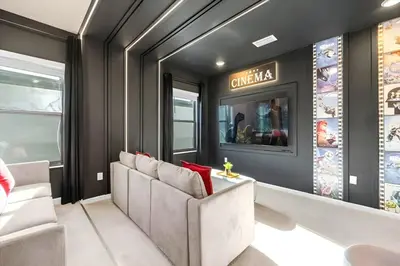 a room with a couch and a sign on the wall at Luxury 12BR Home w Pool Game Room in Orlando