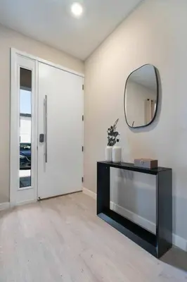 a living room with a mirror and a table at 3BR Home w Game Room Near Disney in Kissimmee