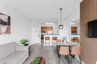 a living room with a couch and a table and chairs at Cozy Apartment at The Point in Orlando