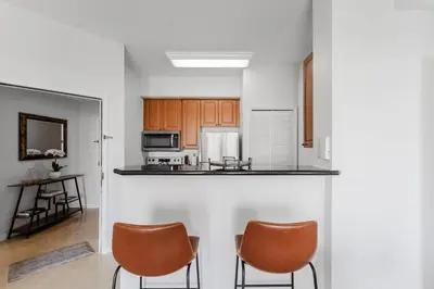 a kitchen with two chairs and a counter top at Cozy Apartment at The Point in Orlando