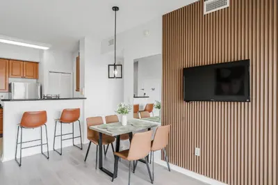 a kitchen and dining room with a table and chairs at Cozy Apartment at The Point in Orlando