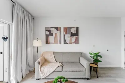 a living room with a couch and a table at Cozy Apartment at The Point in Orlando
