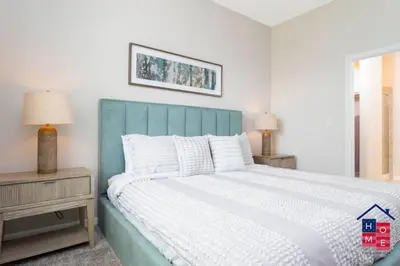 a bedroom with a large bed with a blue headboard at Luxury Condo Near Disney and Resort Access in Kissimmee