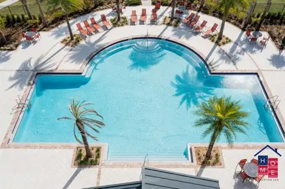 an overhead view of a swimming pool with palm trees at Luxury Condo Near Disney and Resort Access in Kissimmee