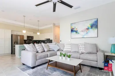 a living room with a couch and a table at Luxury Condo Near Disney and Resort Access in Kissimmee