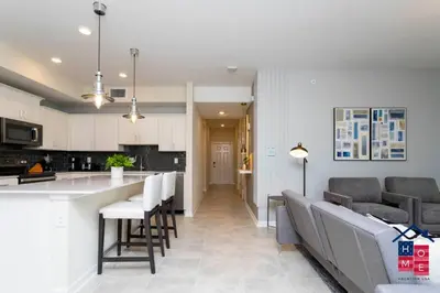 a kitchen and living room with a table and chairs at Lake View Condo with Resort in Kissimmee
