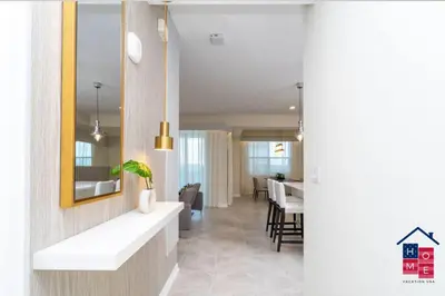 a living room with a table and a dining room at Lake View Condo with Resort in Kissimmee
