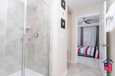 a bathroom with a shower with a glass door at Vibrant Family Condo -10 Min From Disney in Kissimmee