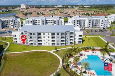an aerial view of a large apartment complex with a pool at Vibrant Family Condo -10 Min From Disney in Kissimmee
