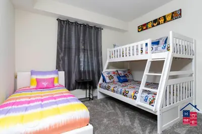 a bedroom with a bunk bed and a white bunk bed at Resort Condo near Disney in Kissimmee