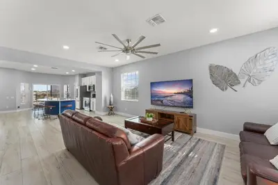 a living room with a couch and a ceiling fan at Windsor Hills View in Orlando