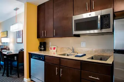 a kitchen with a sink and a microwave at TownePlace Suites Orlando at FLAMINGO CROSSINGS Town Center, Western Entrance in Orlando