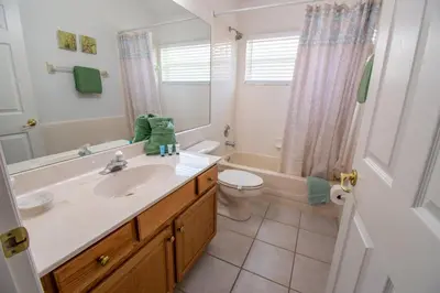 a bathroom with a sink and a toilet and a tub at Free pool-spa heat - Near Disney - Nature view in Orlando