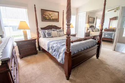 a bedroom with a four poster bed and a mirror at Free pool-spa heat - Near Disney - Nature view in Orlando