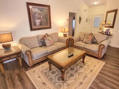 a living room with two couches and a coffee table at Rocco's Retreat in Orlando