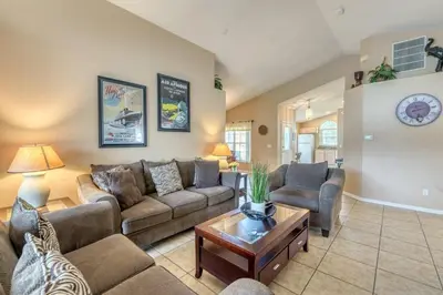 a living room with a couch and a table at Safari Lodge in Orlando