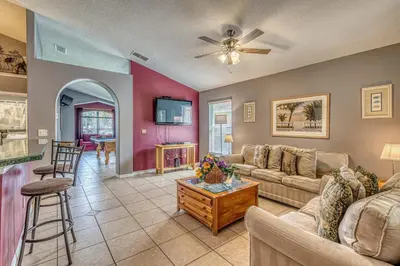a living room with a couch and a table at Pool Paradise in Orlando