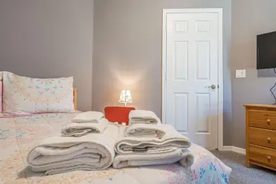 a bedroom with a bed with towels on it at Pool Paradise in Orlando