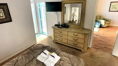a bedroom with a bed and a dresser with a mirror at Minnie's Marvel in Kissimmee