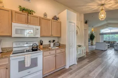 a kitchen with white appliances and wooden cabinets at The Boat House in Orlando