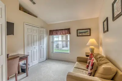 a living room with a couch and a window at The Boat House in Orlando