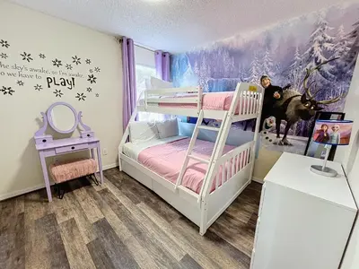 a childs bedroom with a bunk bed and a mural at Island Paradise in Kissimmee