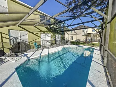 a swimming pool in a building with an open structure at Island Paradise in Kissimmee