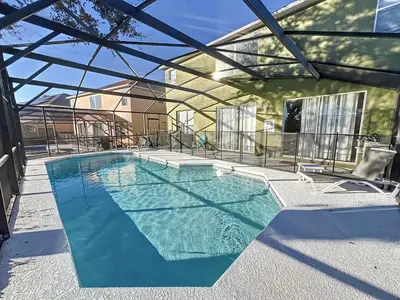 a swimming pool in a house with a glass ceiling at Island Paradise in Kissimmee