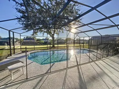 a view of a swimming pool through a glass enclosure at Island Paradise in Kissimmee