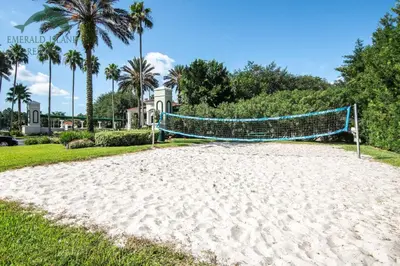 a volleyball net on a beach in front of a house at Island Paradise in Kissimmee