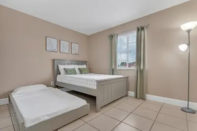 a bedroom with two beds and a window at Lakefront Home with Game Room and Views in Kissimmee