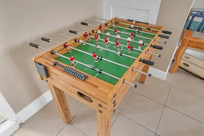a wooden snooker table with avertisement for at Lakefront Home with Game Room and Views in Kissimmee