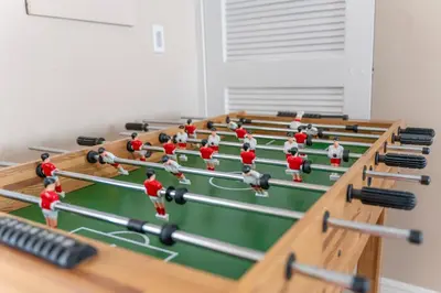 a group of people playing a game of table tennis at Lakefront Home with Game Room and Views in Kissimmee