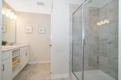 a bathroom with a shower stall and a sink at Condo in the Heart of Orlando - 10 Min from Disney in Kissimmee