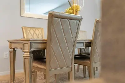 a dining room table with two chairs and a wooden table at Casa 4Q perto da Disney + Piscina no Clube in Kissimmee
