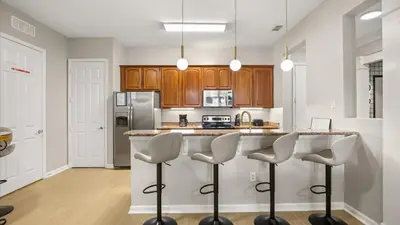 a kitchen with a island with bar stools at Upstay Newly Renovated Family Retreat Home Near Epic Universe in Orlando