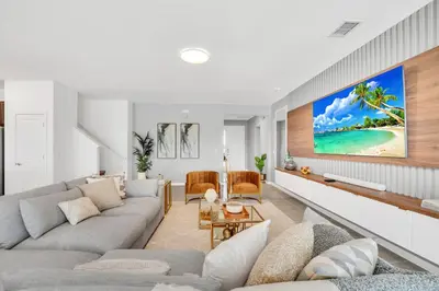 a living room with a couch and a tv at Disney-Adjacent 15Bd15Ba Oasis With Private Pool in Kissimmee