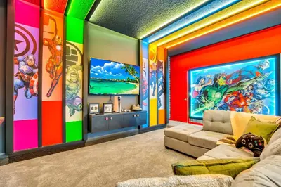 a room with a colorful wall with a couch at Disney-Adjacent 15Bd15Ba Oasis With Private Pool in Kissimmee