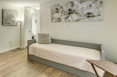 a bedroom with a bed and a table and a painting at Gateway to Orlando Theme Parks! Home with Large Yard in Orlando