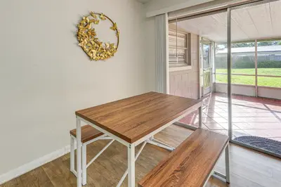 a dining room with a table and a mirror on the wall at Gateway to Orlando Theme Parks! Home with Large Yard in Orlando
